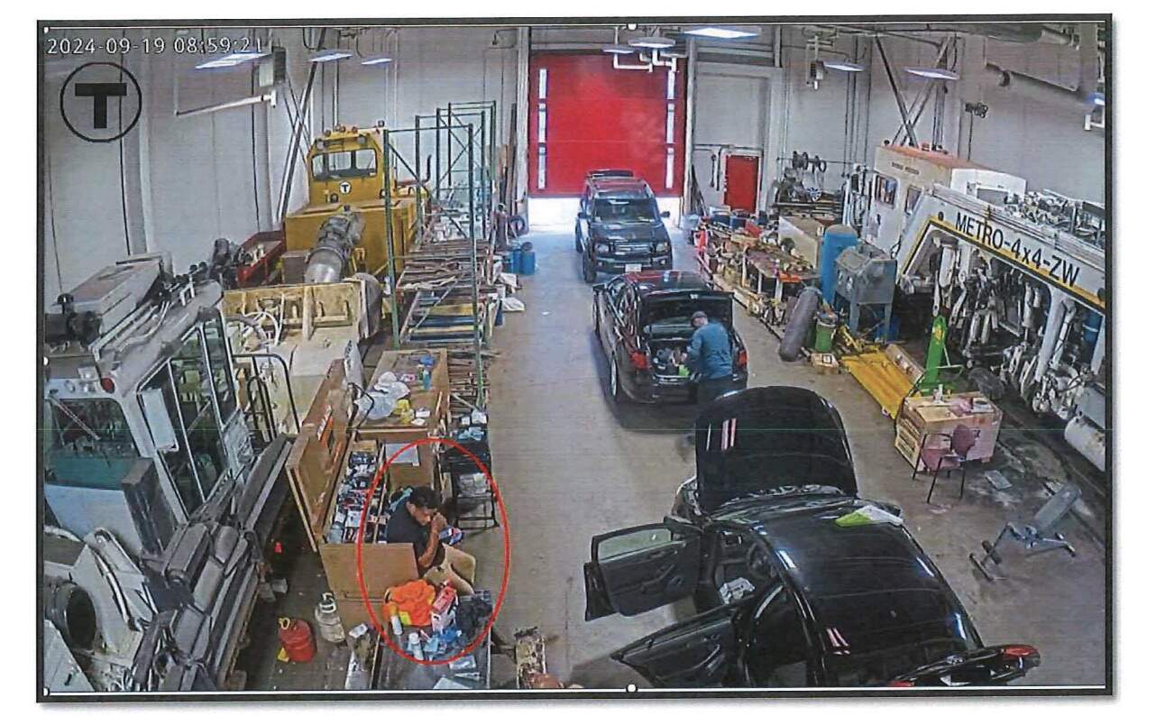 A photo included in the indictment of former MBTA workers accused of falsifying track inspection records. This image allegedly shows inspector Andy Vicente talking on a phone when he claimed he was completing an inspection. (Source: U.S. District Attorney's Office Of Massachusetts)